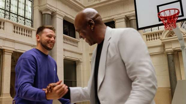 Luka Doncic shakes hands with Michael Jordan.